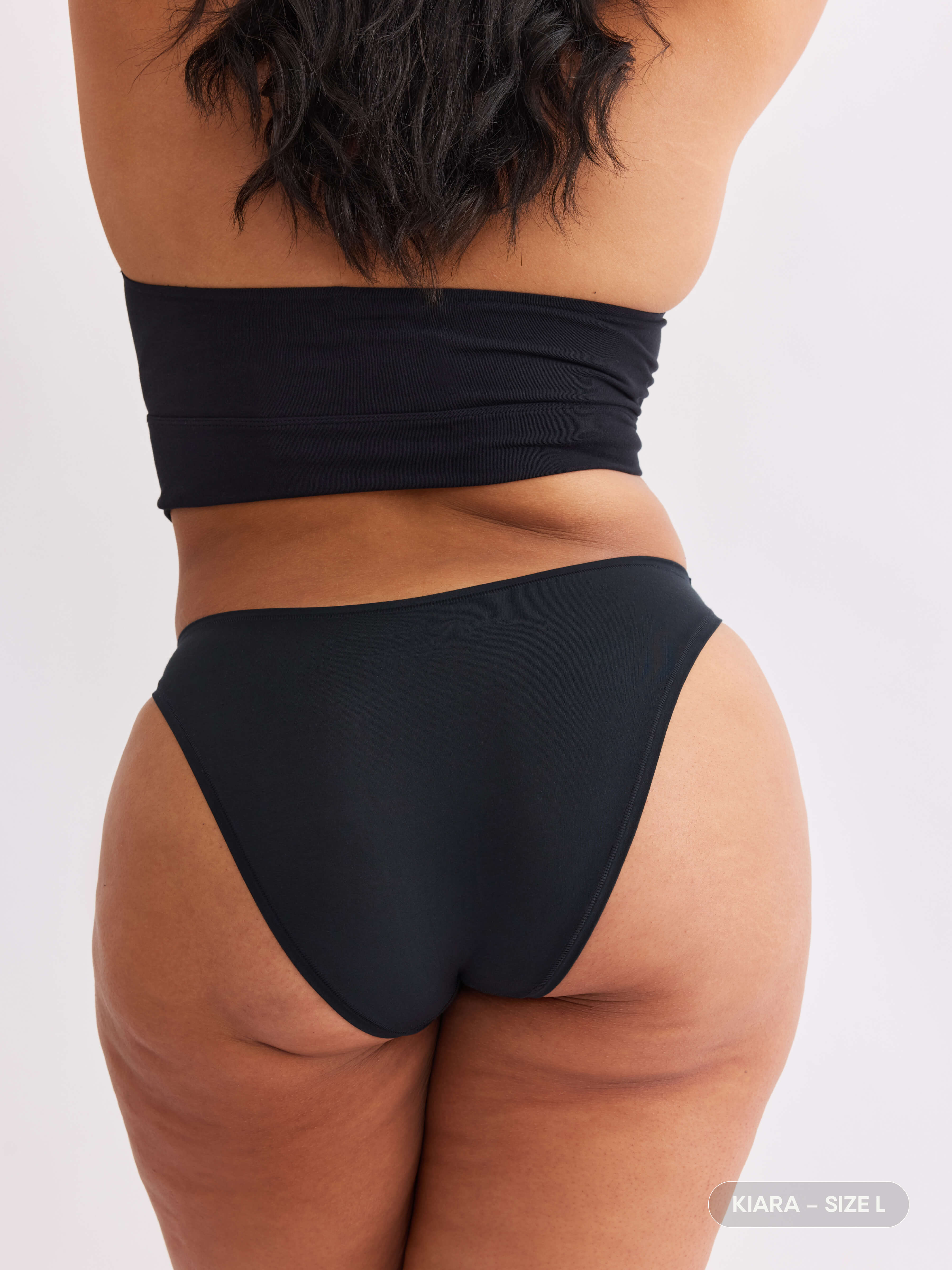 model B wearing vesper black pair of sustainable non-toxic women's underwear back view #color_vesper