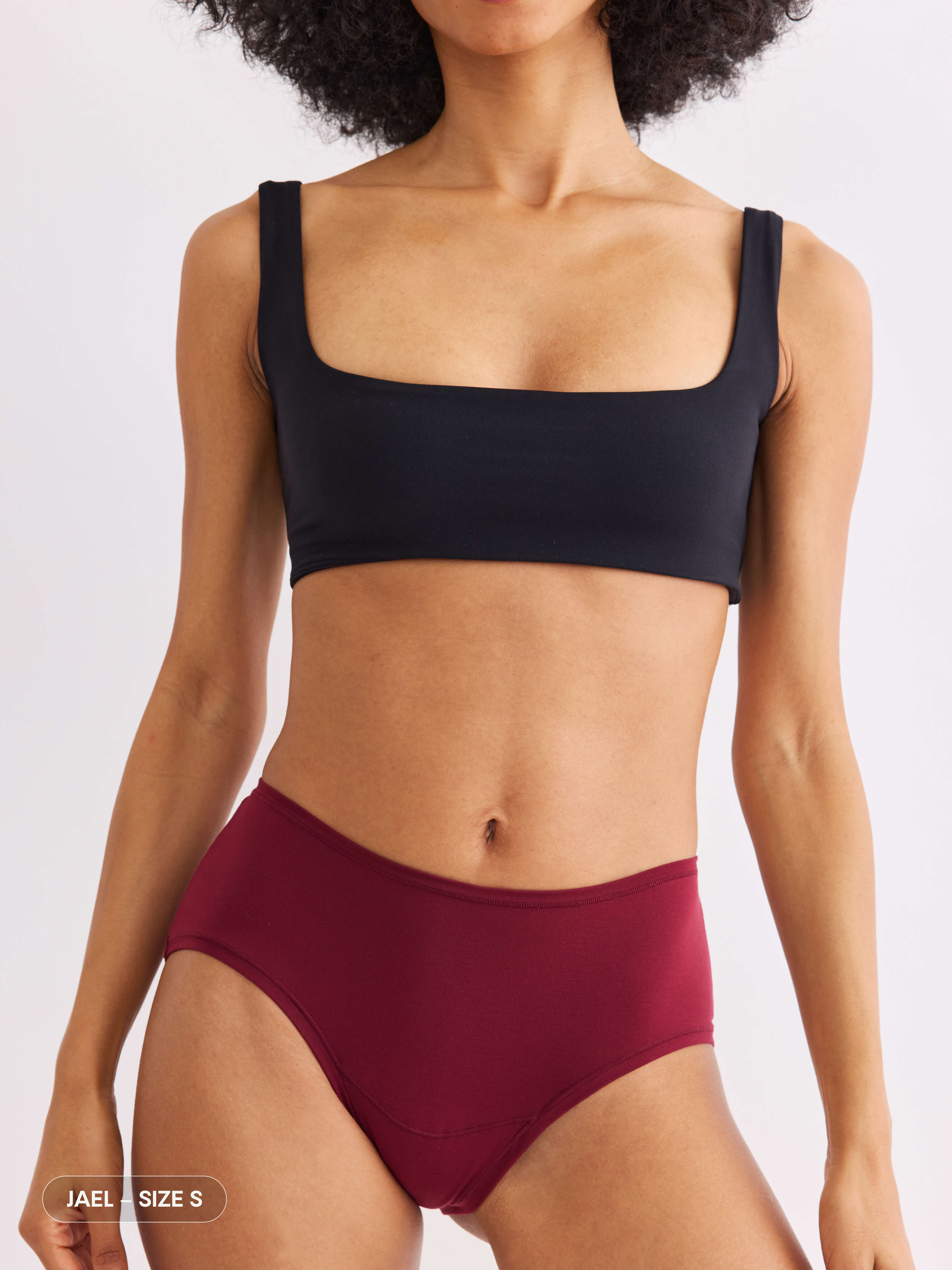 model C wearing red pair of sustainable non-toxic women's underwear front view