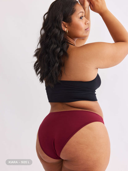 model A wearing merlot red pair of sustainable non-toxic women's underwear  back view 