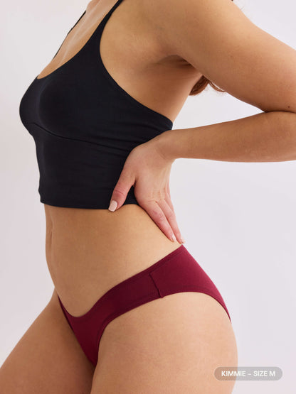 model C wearing merlot red pair of sustainable non-toxic women's underwear  side view 