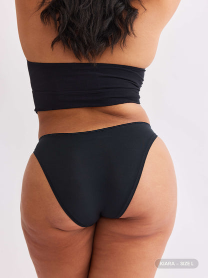 model B wearing vesper black pair of sustainable non-toxic women's underwear  back view 