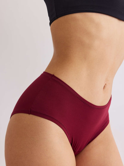 model A wearing red pair of sustainable non-toxic women's underwear front view 