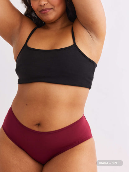 model B wearing red pair of sustainable non-toxic women's underwear front view 