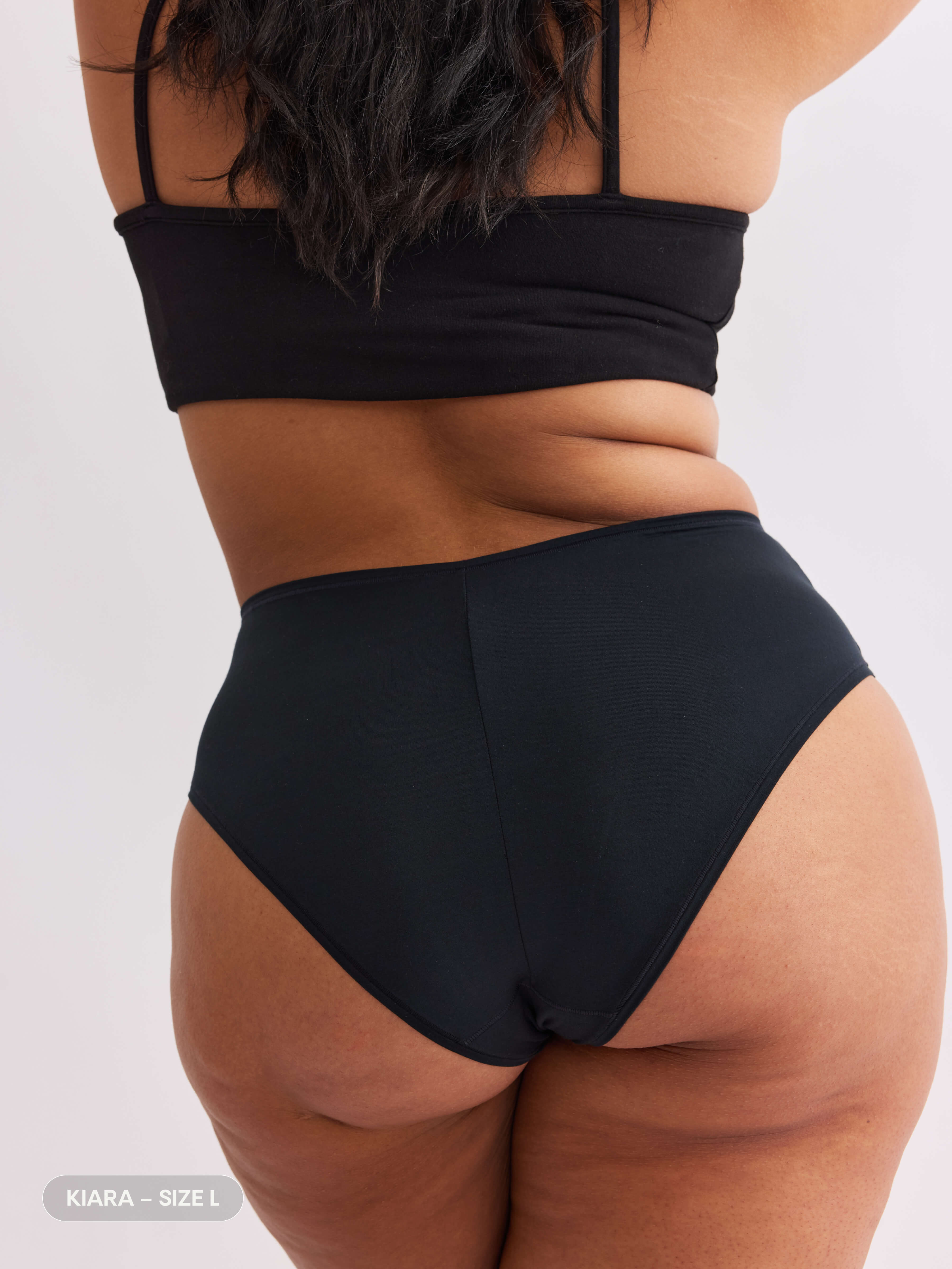 Model A wearing vesper black pair of sustainable non-toxic women's  high waisted underwear back #color_vesper 