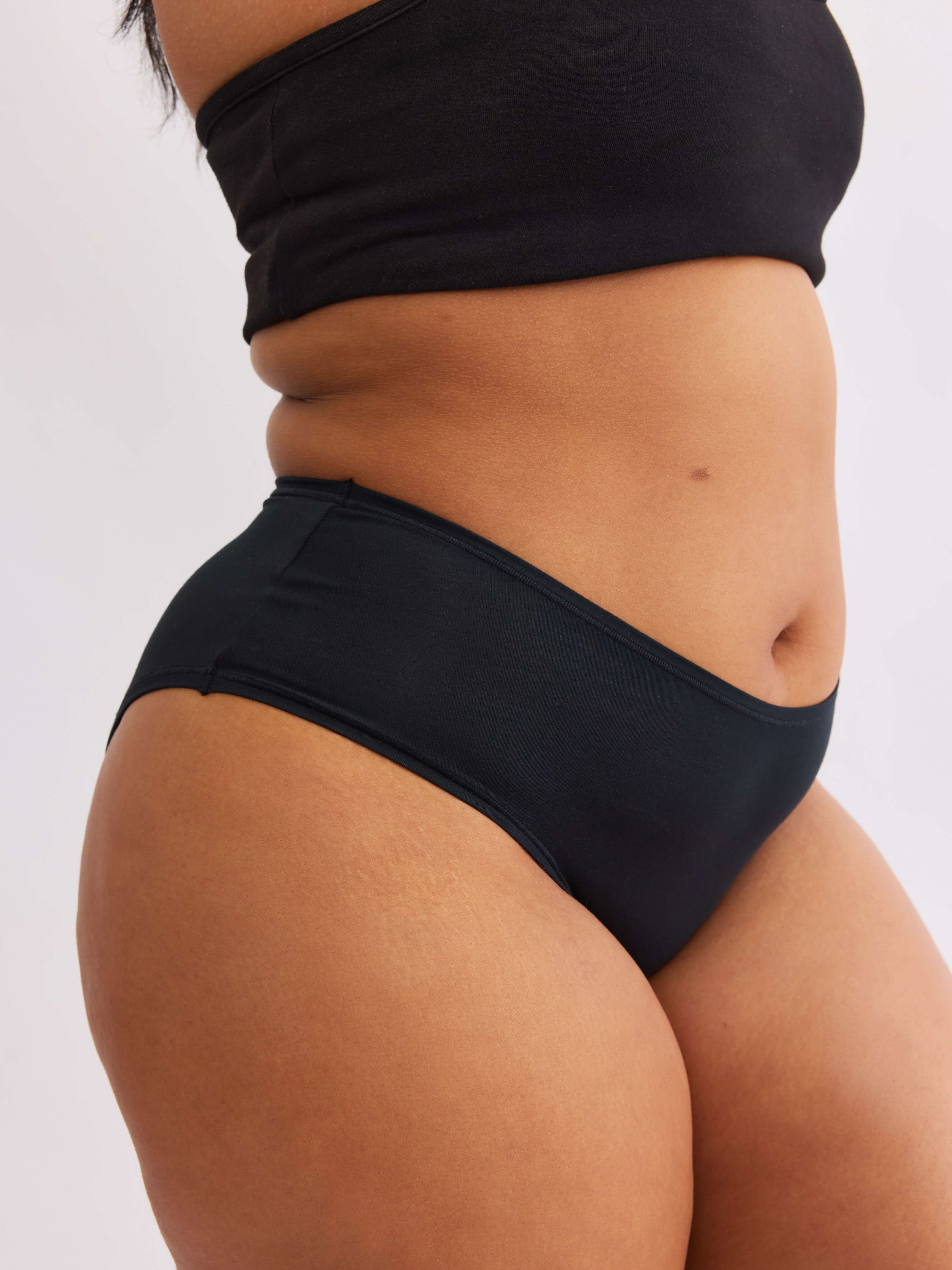 Model A wearing vesper black pair of sustainable non-toxic women's  high waisted underwear front #color_vesper