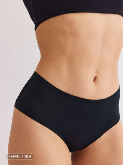 model B wearing black pair of sustainable non-toxic women's underwear front view 