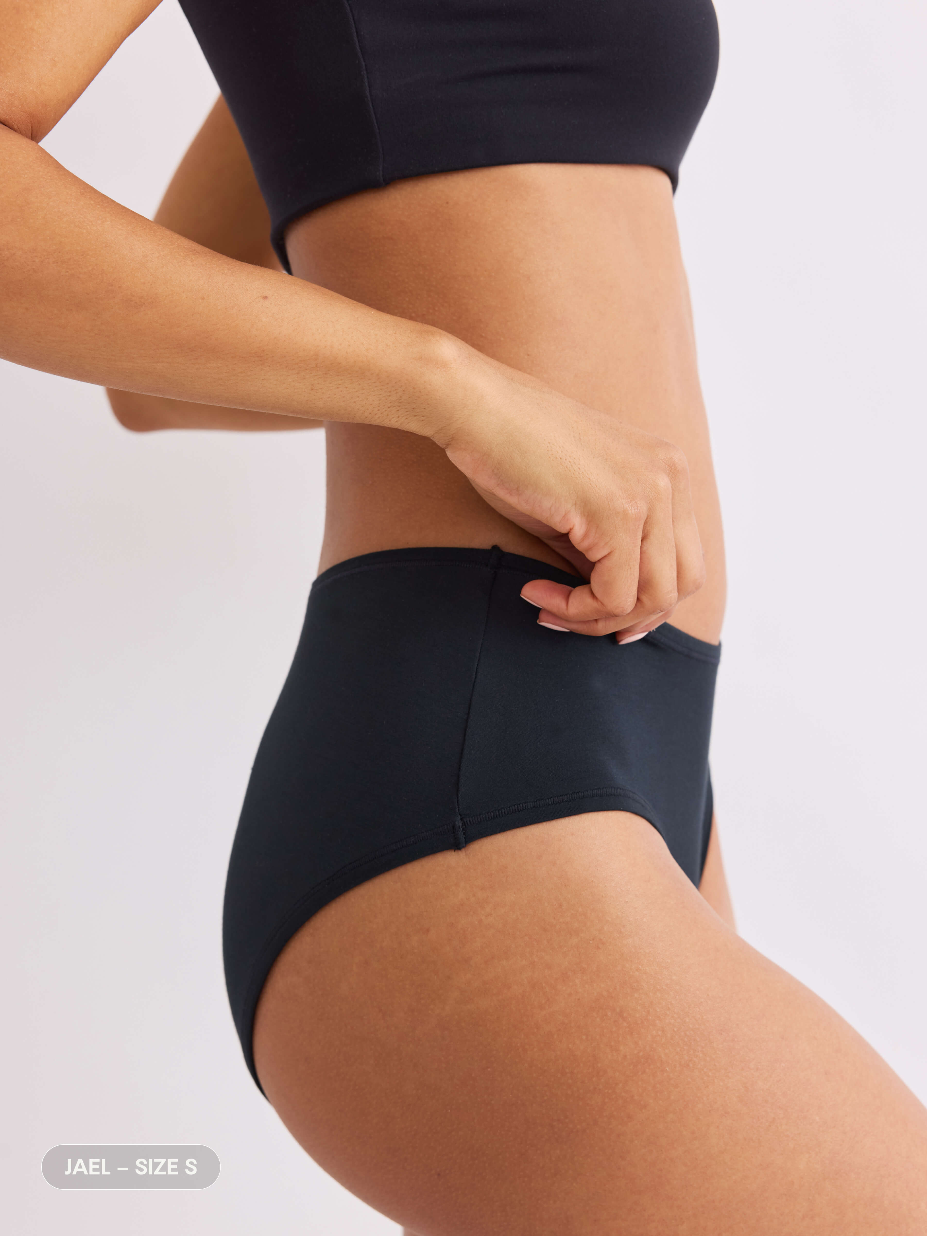 model C wearing black pair of sustainable non-toxic women's underwear side view 